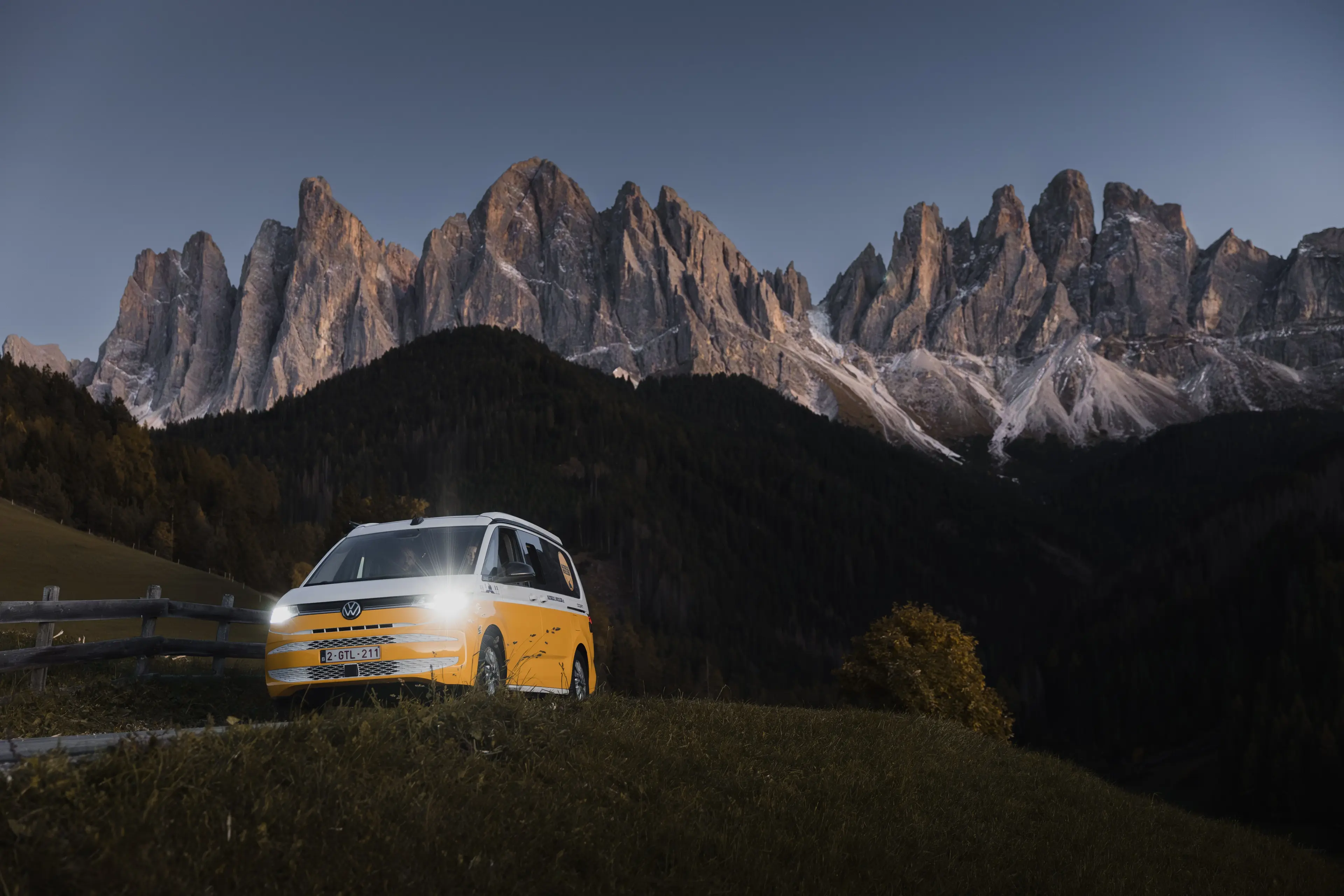 A campervan with a mountain backdrop