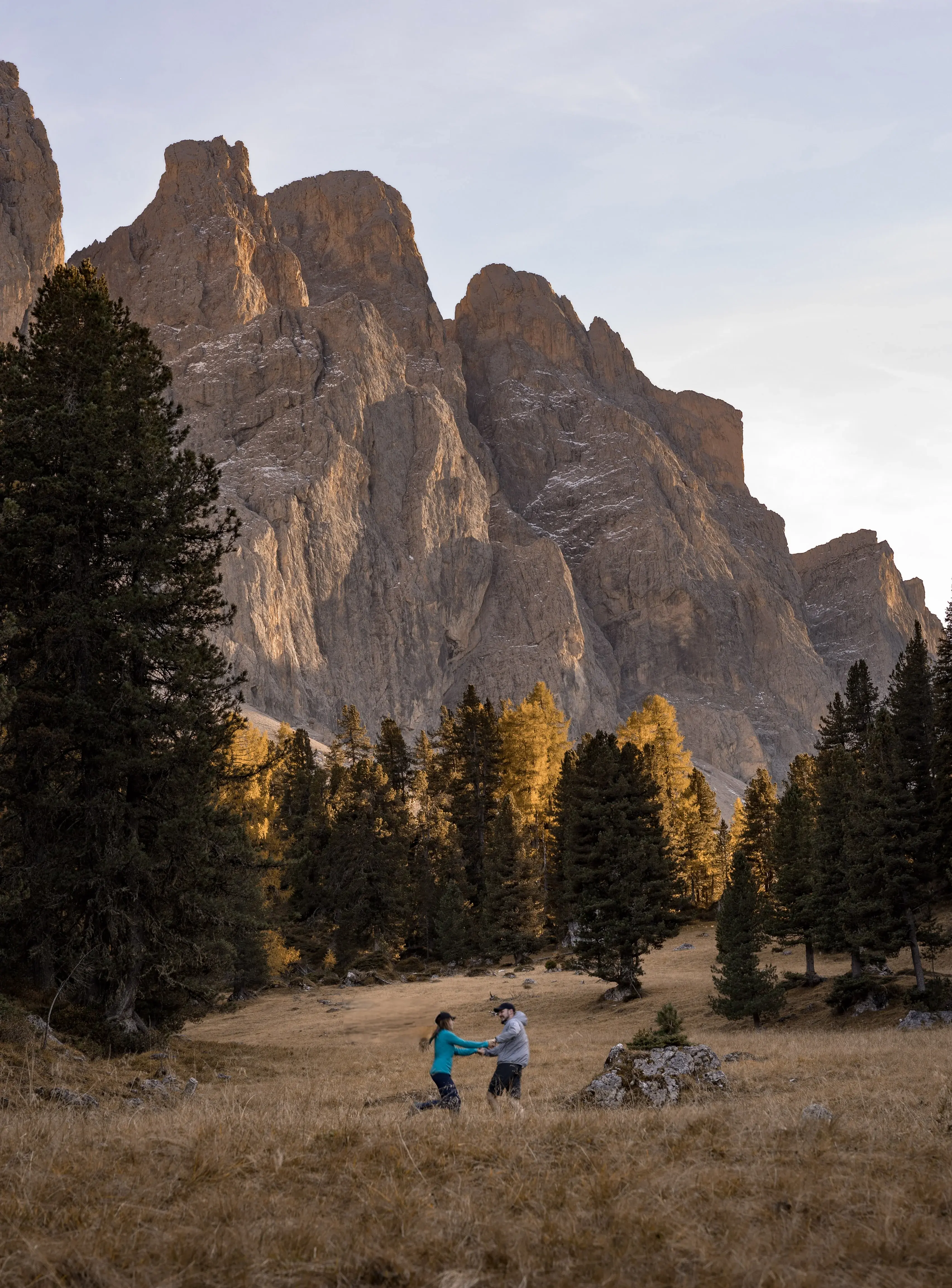 Two people swirling in the autumn grass